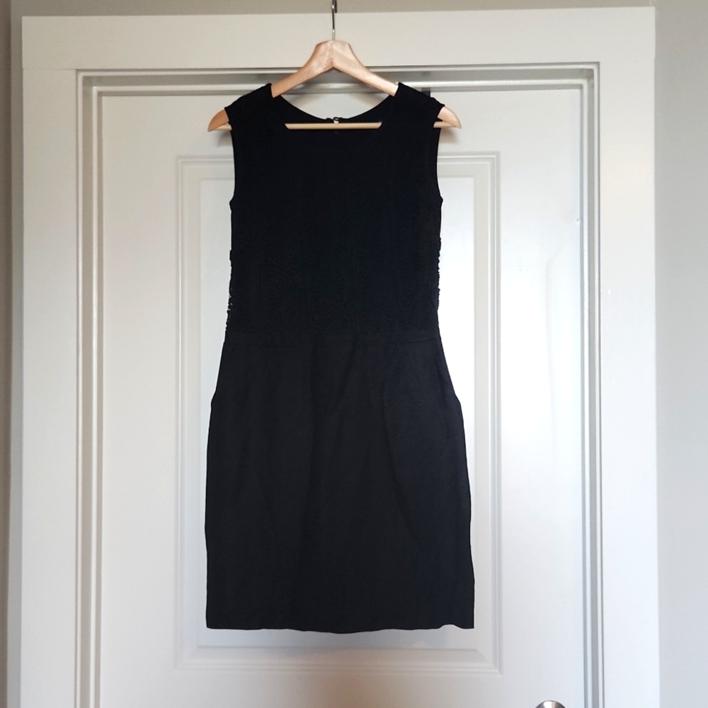 Black Mini Dress with pockets . Detailed patterned top half. US size 6